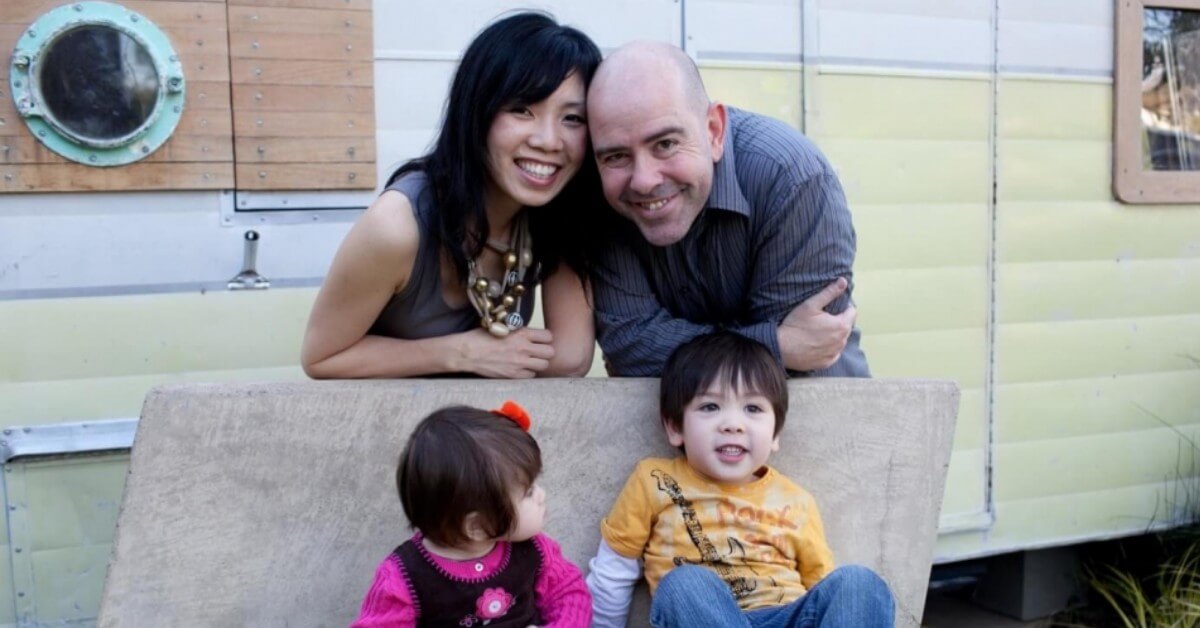 Marc Garlett, estate planning lawyer, with his wife and children, smiling in front of their camper.
